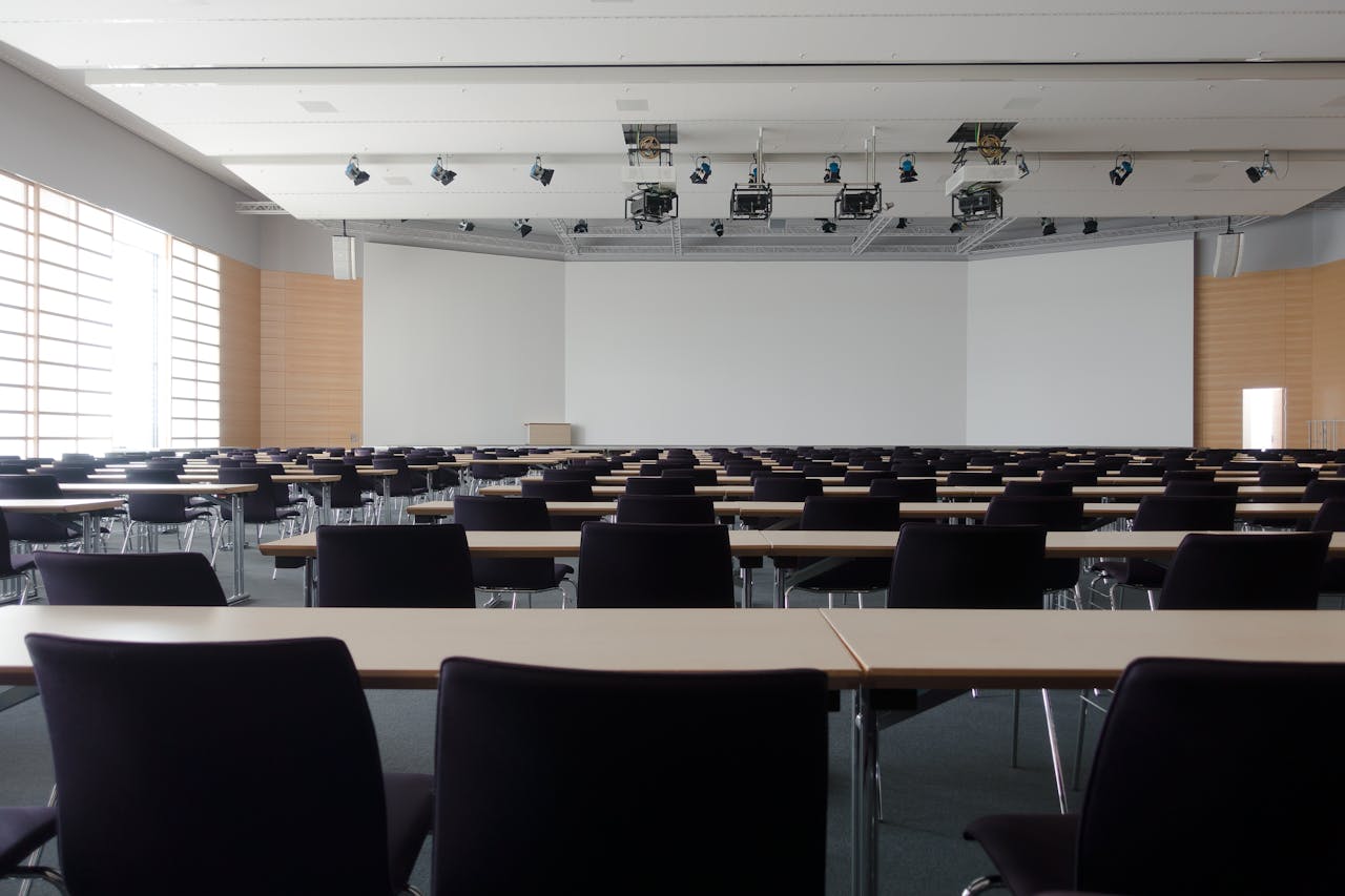 Crafting Captivating Headlines: Your awesome post title goes here Spacious contemporary conference room with rows of tables and chairs, ready for meetings.